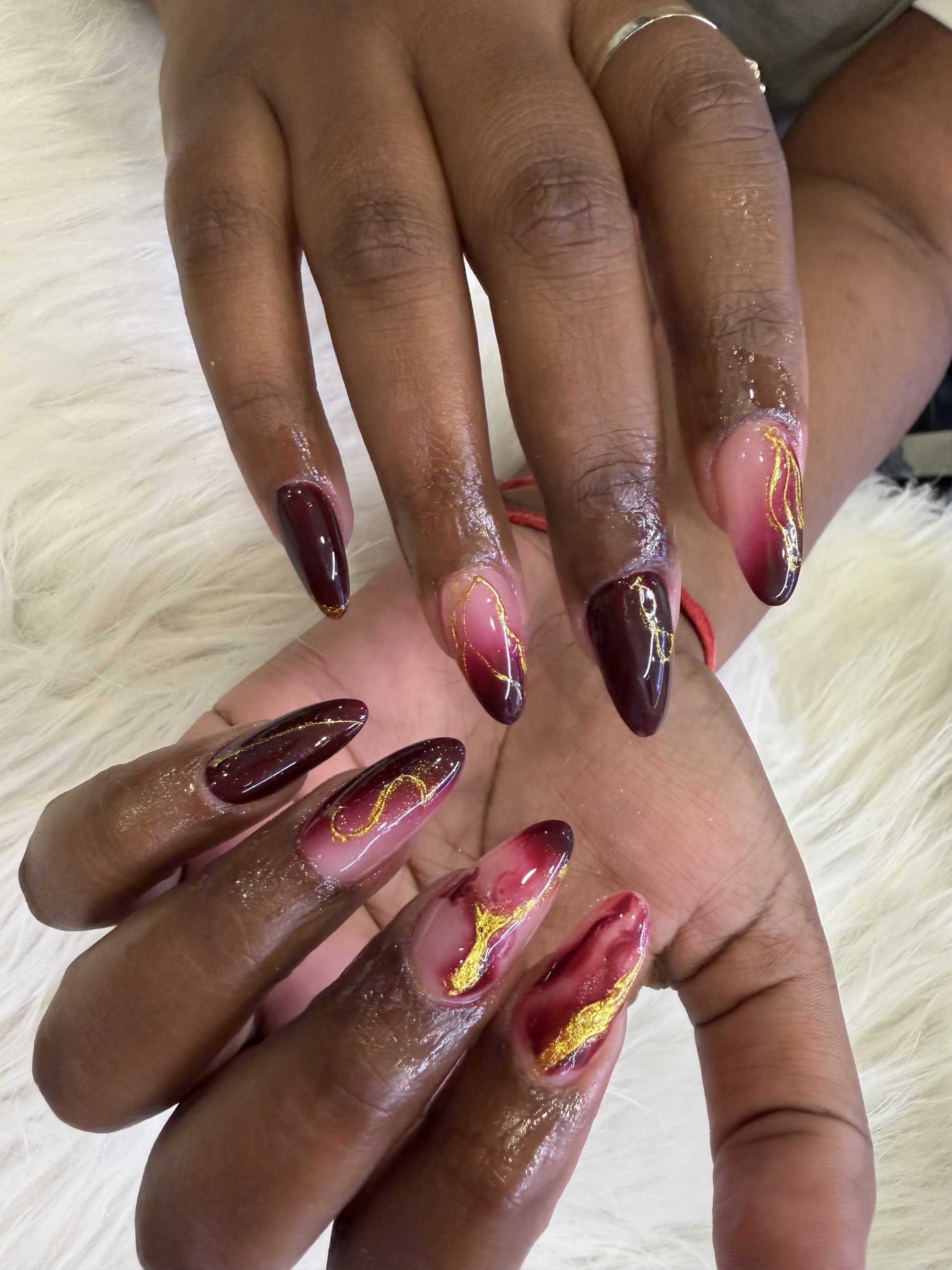 Burgundy and wine ombre almond nails with gold foil accents