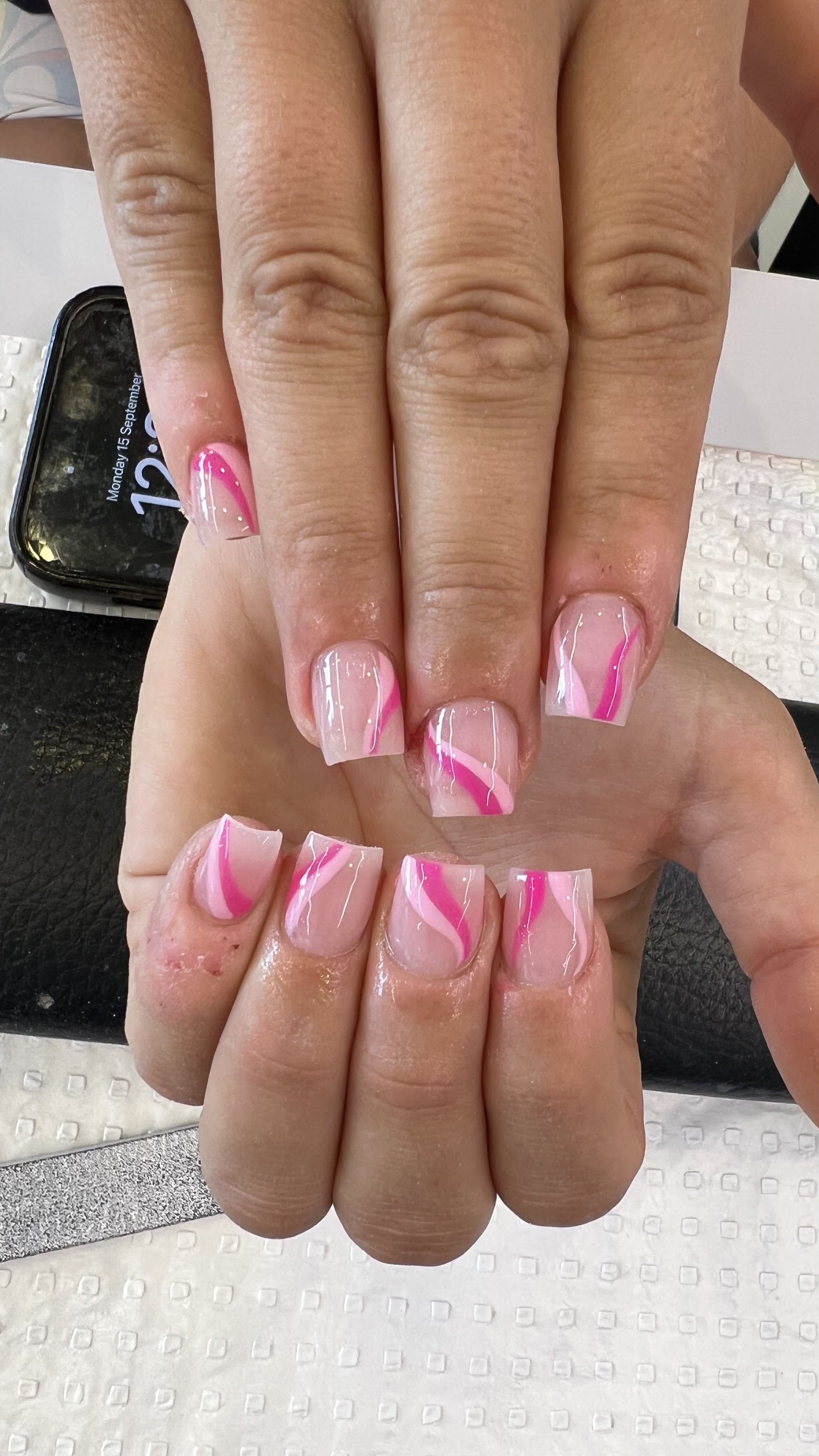 Soft nude French tips with pink swirl line art and rhinestones, square shape